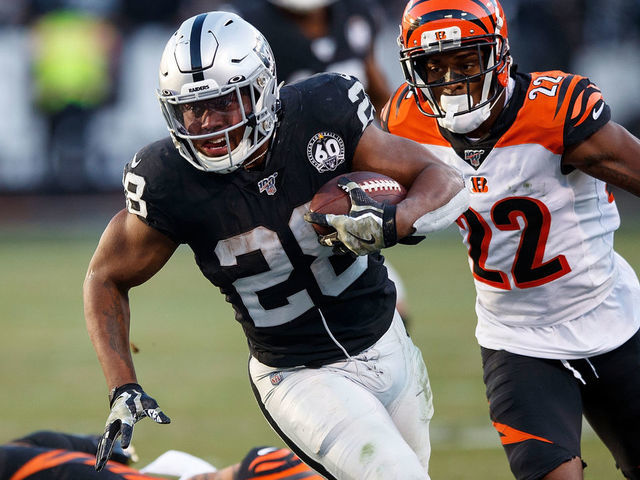 OAKLAND, CA - NOVEMBER 17: Running back Josh Jacobs #28 of the Oakland Raiders rushes past free safety Jessie Bates #30 of the Cincinnati Bengals and cornerback William Jackson #22 during the fourth quarter at RingCentral Coliseum on November 17, 2019 in Oakland, California. The Oakland Raiders defeated the Cincinnati Bengals 17-10.