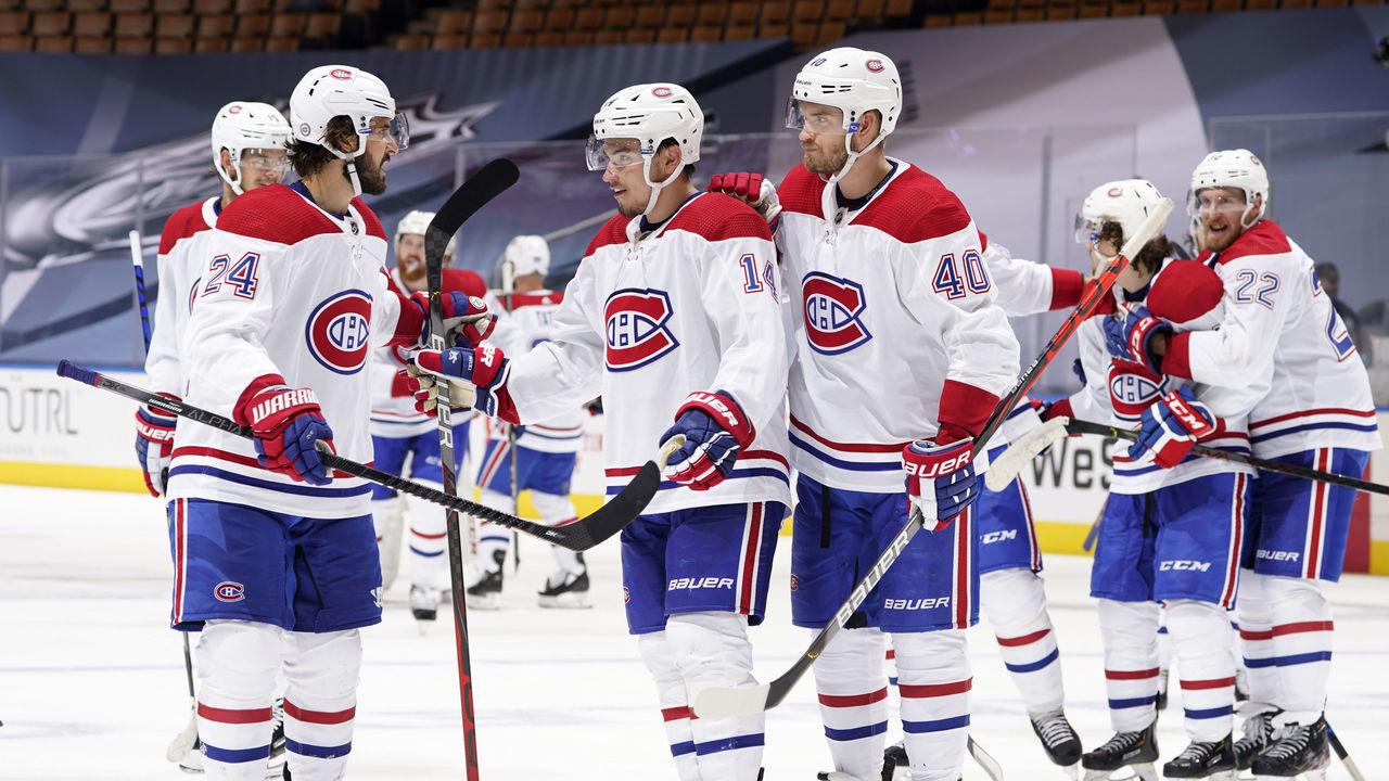 TORONTO, ONTARIO - AUGUST 01: Phillip Danault #24, Nick Suzuki #14 and Joel Armia #40 of the Montreal Canadiens celebrate defeating the Pittsburgh Penguins 3-2 in overtime of Game One of the Eastern Conference Qualification Round at Scotiabank Arena on August 01, 2020 in Toronto, Ontario.