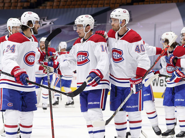 TORONTO, ONTARIO - AUGUST 01: Phillip Danault #24, Nick Suzuki #14 and Joel Armia #40 of the Montreal Canadiens celebrate defeating the Pittsburgh Penguins 3-2 in overtime of Game One of the Eastern Conference Qualification Round at Scotiabank Arena on August 01, 2020 in Toronto, Ontario.