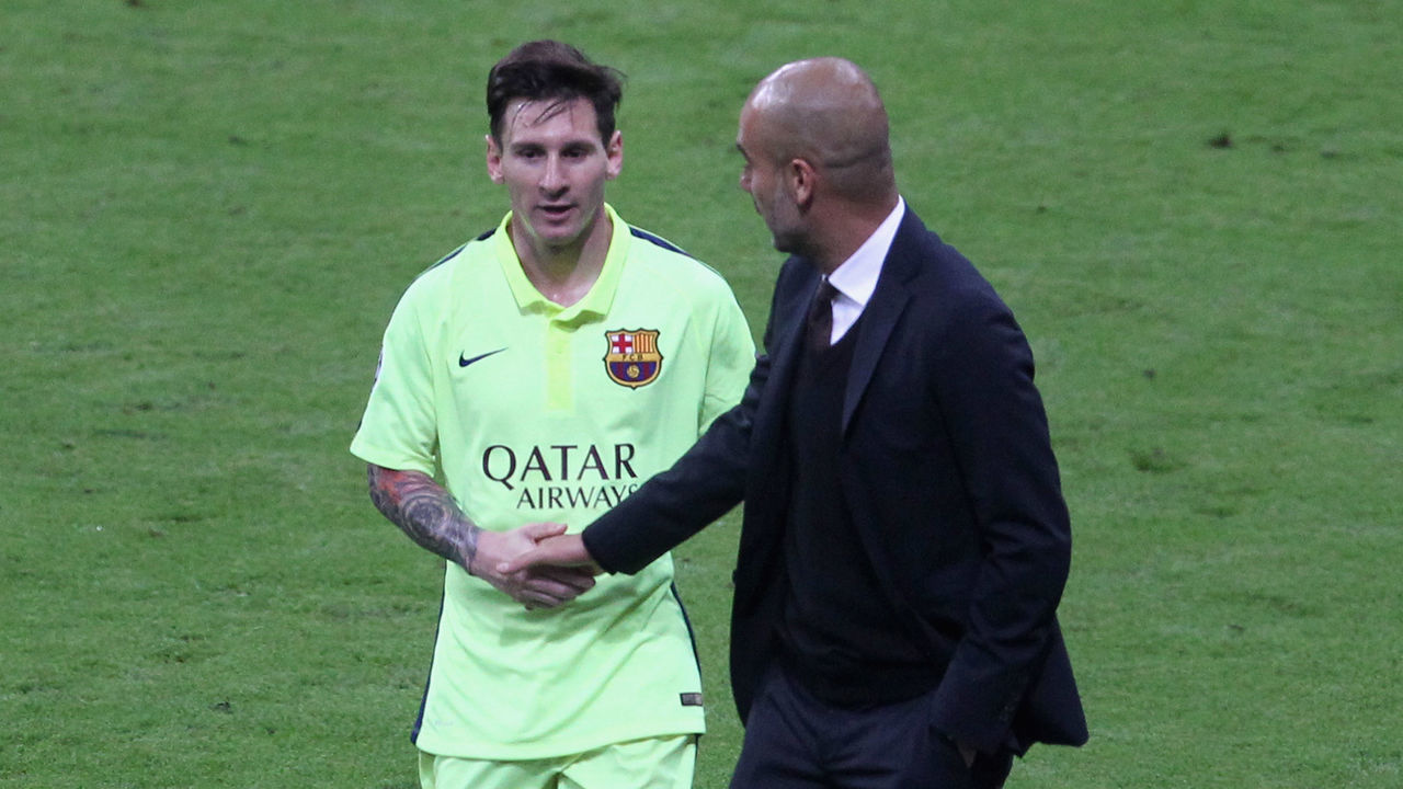 MUNICH, GERMANY - MAY 12: Team coach Josep Guardiola (R) of Bayern Muenchen shakes hands with Lionel Messi of FC Barcelona during half-time of the UEFA Champions League semi final second leg match between FC Bayern Muenchen and FC Barcelona at Allianz Arena on May 12, 2015 in Munich, Germany.