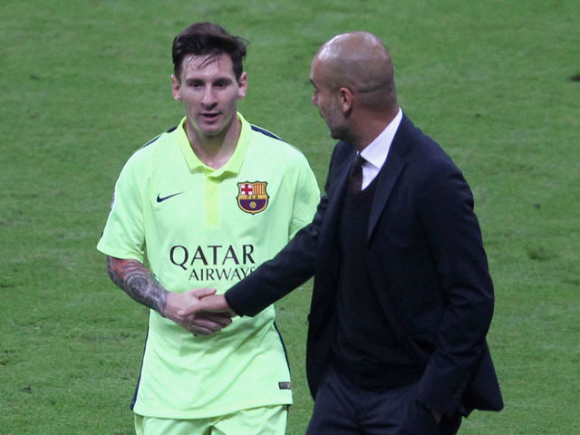 MUNICH, GERMANY - MAY 12: Team coach Josep Guardiola (R) of Bayern Muenchen shakes hands with Lionel Messi of FC Barcelona during half-time of the UEFA Champions League semi final second leg match between FC Bayern Muenchen and FC Barcelona at Allianz Arena on May 12, 2015 in Munich, Germany.
