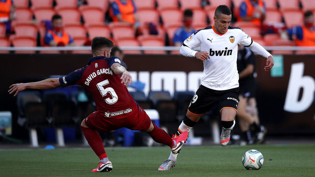 VALENCIA, SPAIN - JUNE 21: Rodrigo Moreno of Valencia CF battles for possession with Raul Navas of CA Osasuna during the La Liga match between Valencia CF and CA Osasuna at Estadio Mestalla on June 21, 2020 in Valencia, Spain.