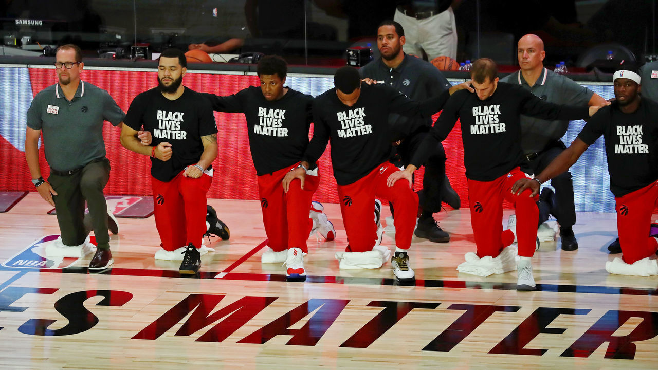 LAKE BUENA VISTA, FLORIDA - AUGUST 21: The Toronto Raptors kneel during the national anthem before game three of the first round of the 2020 NBA Playoffs against the Brooklyn Nets at The Field House at ESPN Wide World Of Sports Complex on August 21, 2020 in Lake Buena Vista, Florida.