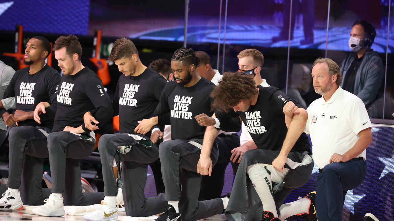ORLANDO, FL - AUGUST 20: The Milwaukee Bucks kneel during the National Anthem before the game against the Orlando Magic during Round One, Game Two of the NBA Playoffs on August 20, 2020 at the The Field House at ESPN Wide World Of Sports Complex in Orlando, Florida. NOTE TO USER: User expressly acknowledges and agrees that, by downloading and/or using this Photograph, user is consenting to the terms and conditions of the Getty Images License Agreement. Mandatory Copyright Notice: Copyright 2020 NBAE