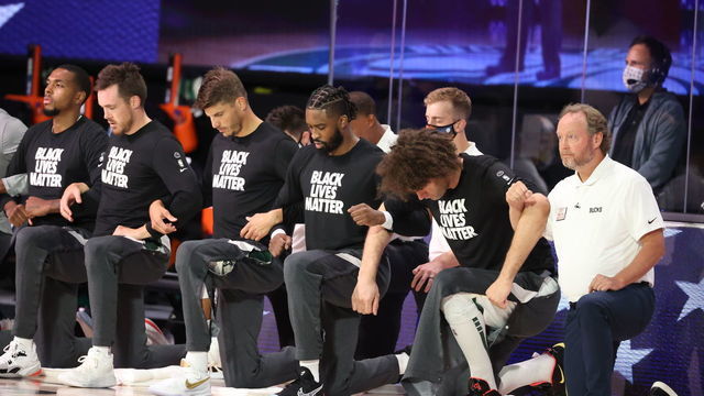 ORLANDO, FL - AUGUST 20: The Milwaukee Bucks kneel during the National Anthem before the game against the Orlando Magic during Round One, Game Two of the NBA Playoffs on August 20, 2020 at the The Field House at ESPN Wide World Of Sports Complex in Orlando, Florida. NOTE TO USER: User expressly acknowledges and agrees that, by downloading and/or using this Photograph, user is consenting to the terms and conditions of the Getty Images License Agreement. Mandatory Copyright Notice: Copyright 2020 NBAE
