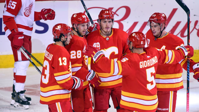 CALGARY, AB - OCTOBER 17: Calgary Flames Right Wing Elias Lindholm (28) celebrates a goal against the Detroit Red Wings with Calgary Flames Left Wing Johnny Gaudreau (13), Left Wing Matthew Tkachuk (19), Center Sean Monahan (23) and Defenceman Mark Giordano (5) during the second period of an NHL game where the Calgary Flames hosted the Detroit Red Wings on October 17, 2019, at the Scotiabank Saddledome in Calgary, AB.