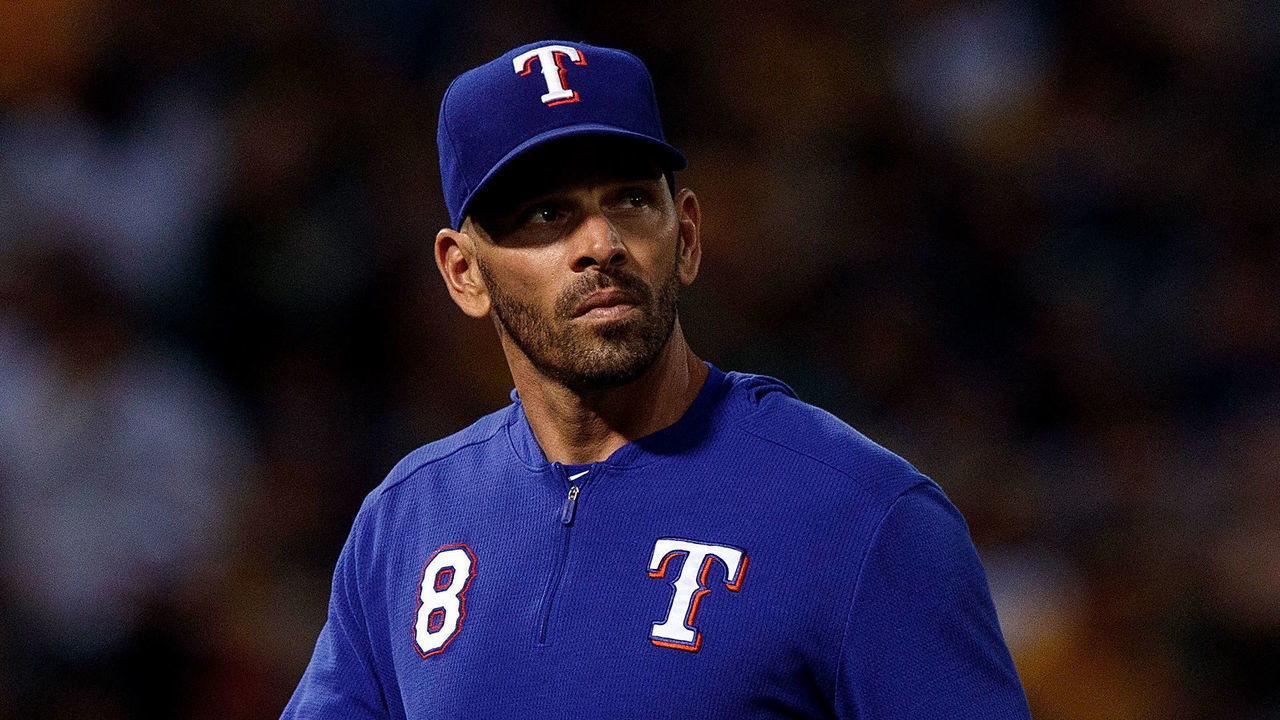 OAKLAND, CA - SEPTEMBER 21: Chris Woodward #8 of the Texas Rangers returns to the dugout after making a pitching change against the Oakland Athletics during the second inning at the RingCentral Coliseum on September 21, 2019 in Oakland, California. The Oakland Athletics defeated the Texas Rangers 12-3.