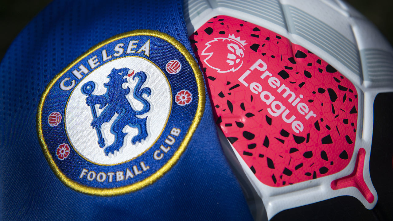 MANCHESTER, ENGLAND - MAY 05: The Chelsea club crest on the first team home shirt displayed with a Premier League match ball and on May 5, 2020 in Manchester, England