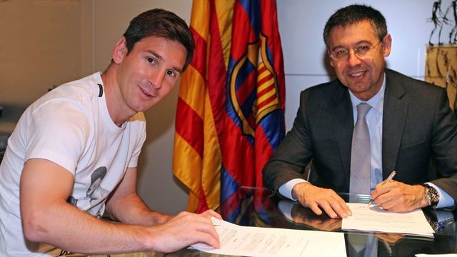 BARCELONA, SPAIN - MAY 19: Lionel Messi (L) of FC Barcelona and the FC Barcelona President Josep Maria Bartomeu pose during the signing of his new contract with FC Barcelona on May 19, 2014 in Barcelona, Spain.