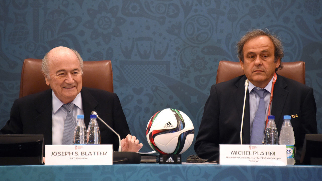 FIFA President Joseph Blatter (L) smiles as he sits next to UEFA President Michel Platini (R) as they join a seminar ahead of the Preliminary Draw for the FIFA World Cup 2018, in St.Petersburg, Russia, 25 July 2015. Photo: MARCUS BRANDT/dpa | usage worldwide