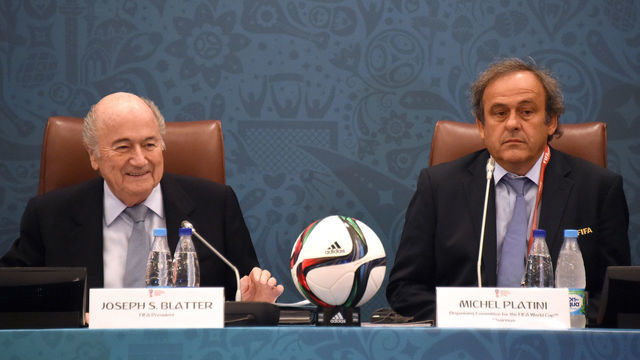 FIFA President Joseph Blatter (L) smiles as he sits next to UEFA President Michel Platini (R) as they join a seminar ahead of the Preliminary Draw for the FIFA World Cup 2018, in St.Petersburg, Russia, 25 July 2015. Photo: MARCUS BRANDT/dpa | usage worldwide