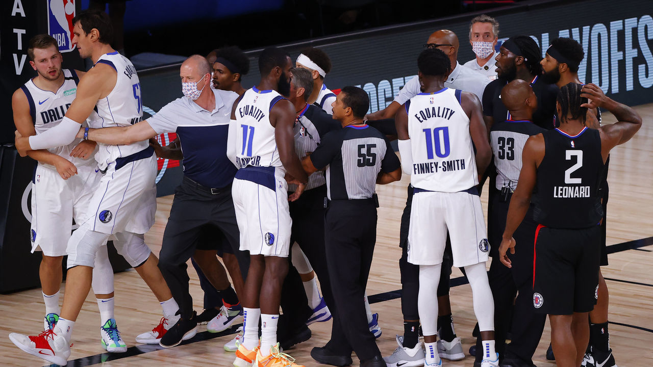 LAKE BUENA VISTA, FLORIDA - AUGUST 30: Players separate Luka Doncic #77 of the Dallas Mavericks and Marcus Morris Sr. #31 of the LA Clippers after Morris fouled Doncic during the first quarter in Game Six of the Western Conference First Round during the 2020 NBA Playoffs at AdventHealth Arena at ESPN Wide World Of Sports Complex on August 30, 2020 in Lake Buena Vista, Florida.