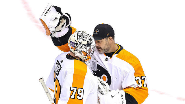 TORONTO, ONTARIO - AUGUST 16: Carter Hart #79 of the Philadelphia Flyers is congratulated by his teammate, Brian Elliott #37 after recording the shutout in his teams 1-0 win against the Montreal Canadiens in Game Three of the Eastern Conference First Round during the 2020 NHL Stanley Cup Playoffs at Scotiabank Arena on August 16, 2020 in Toronto, Ontario.
