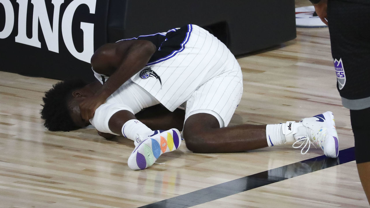 LAKE BUENA VISTA, FLORIDA - AUGUST 02: Jonathan Isaac #1 of the Orlando Magic reacts after an injury against the Sacramento Kings in the second half of a NBA basketball game at HP Field House at ESPN Wide World Of Sports Complex on August 2, 2020 in Lake Buena Vista, Florida.