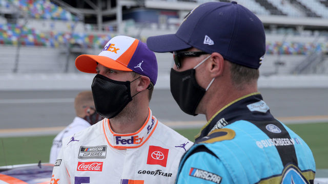 DAYTONA BEACH, FLORIDA - AUGUST 16: Denny Hamlin, driver of the #11 FedEx Freight Toyota, and Kevin Harvick, driver of the #4 Busch Beer National Forest Foundation Ford, talk on the grid prior to the NASCAR Cup Series Go Bowling 235 at Daytona International Speedway on August 16, 2020 in Daytona Beach, Florida.