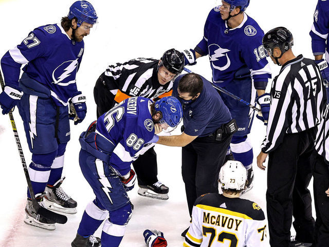 TORONTO, ONTARIO - AUGUST 31: Nikita Kucherov #86 of the Tampa Bay Lightning is tended to by the trainer after sustaining an injury on a high-sticking penalty by Zdeno Chara (not pictured) of the Boston Bruins during the first period in Game Five of the Eastern Conference Second Round during the 2020 NHL Stanley Cup Playoffs at Scotiabank Arena on August 31, 2020 in Toronto, Ontario.
