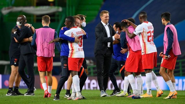 Leipzig's German headcoach Julian Nagelsmann (C) and his players celebrate their win at the end of the UEFA Champions League quarter-final football match between Leipzig and Atletico Madrid at the Jose Alvalade stadium in Lisbon on August 13, 2020.