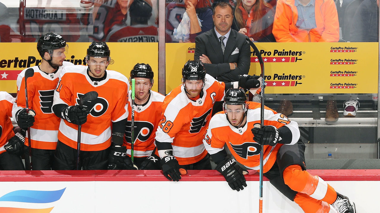 PHILADELPHIA, PA - OCTOBER 09: Head Coach of the Philadelphia Flyers Alain Vigneault with Scott Laughton #21, Carsen Twarynski #81, James van Riemsdyk #25, Claude Giroux #28 and Kevin Hayes #13 watch as play develops in the first period against the New Jersey Devils on October 9, 2019 at the Wells Fargo Center in Philadelphia, Pennsylvania.