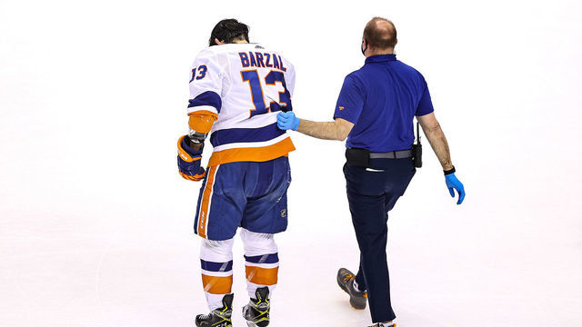 TORONTO, ONTARIO - SEPTEMBER 01: Mathew Barzal #13 of the New York Islanders is helped off the ice by the trainer after being hit in the face with a stick against the Philadelphia Flyers during the third period in Game Five of the Eastern Conference Second Round during the 2020 NHL Stanley Cup Playoffs at Scotiabank Arena on September 01, 2020 in Toronto, Ontario.