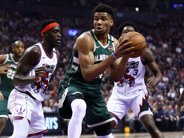 TORONTO, ON - FEBRUARY 25: Giannis Antetokounmpo #34 of the Milwaukee Bucks dribbles the ball as Pascal Siakam #43 of the Toronto Raptors defends during the first half of an NBA game at Scotiabank Arena on February 25, 2020 in Toronto, Canada.