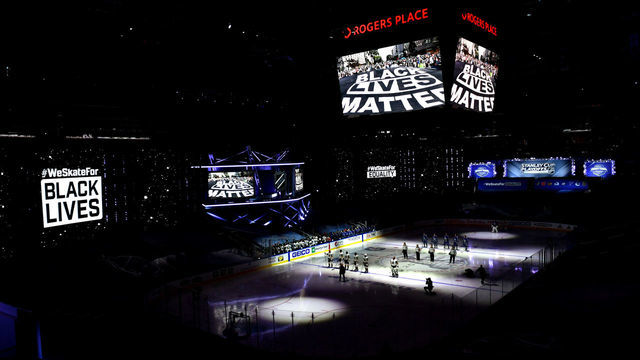 EDMONTON, ALBERTA - AUGUST 29: A general view of the Vegas Golden Knights and the Vancouver Canucks players standing on the ice during pregame as "Black Lives Matter" is seen on arena screens as the NHL unite in the cause to end racism before Game Three of the Western Conference Second Round during the 2020 NHL Stanley Cup Playoffs at Rogers Place on August 29, 2020 in Edmonton, Alberta.