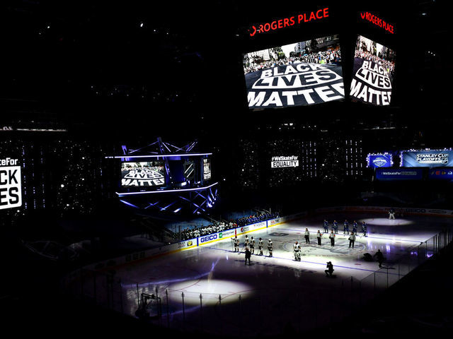 EDMONTON, ALBERTA - AUGUST 29: A general view of the Vegas Golden Knights and the Vancouver Canucks players standing on the ice during pregame as "Black Lives Matter" is seen on arena screens as the NHL unite in the cause to end racism before Game Three of the Western Conference Second Round during the 2020 NHL Stanley Cup Playoffs at Rogers Place on August 29, 2020 in Edmonton, Alberta.