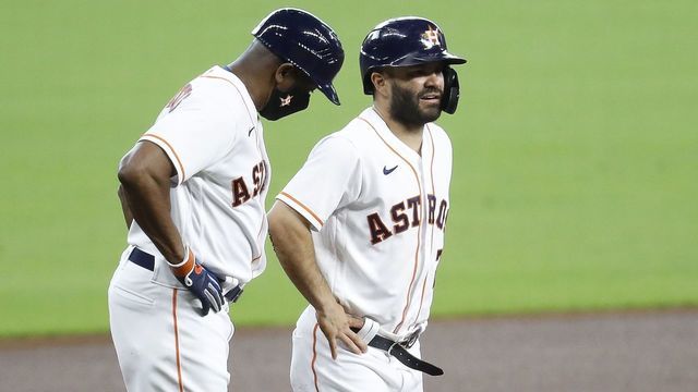 HOUSTON, TEXAS - SEPTEMBER 03: Jose Altuve #27 of the Houston Astros talks with third base coach Gary Pettis #8 after he appeared to injure himself sliding into third base in the first inning \AT\ at Minute Maid Park on September 03, 2020 in Houston, Texas.