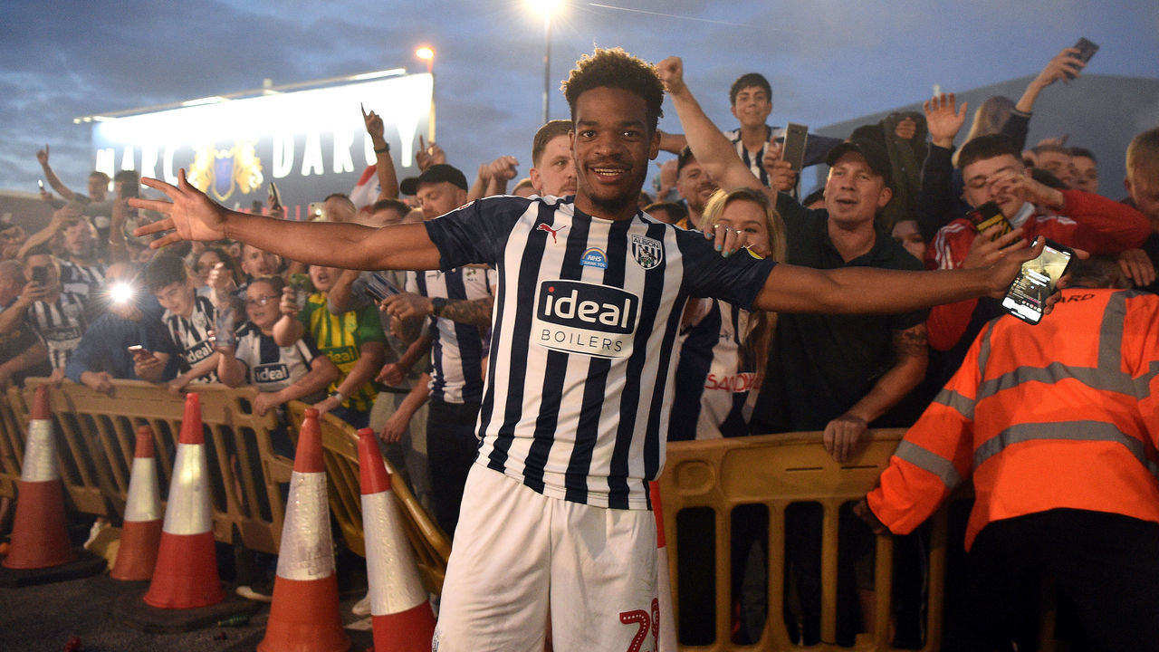 WEST BROMWICH, ENGLAND - JULY 22: Grady Diangana of West Bromwich Albion celebrates with the fans outside the stadium after during the Sky Bet Championship match between West Bromwich Albion and Queens Park Rangers at The Hawthorns on July 22, 2020 in West Bromwich, England. Football Stadiums around Europe remain empty due to the Coronavirus Pandemic as Government social distancing laws prohibit fans inside venues resulting in all fixtures being played behind closed doors.