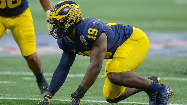 ATLANTA, GA DECEMBER 29: Michigan's Kwity Paye (19) prepares to rush the quarterback during the Chick-fil-A Peach Bowl between the Michigan Wolverines and the Florida Gators on December 29th, 2018 at Mercedes-Benz Stadium in Atlanta, GA.