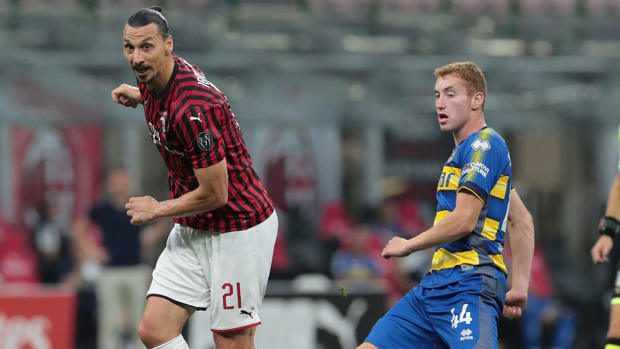 MILAN, ITALY - JULY 15: Zlatan Ibrahimovic of AC Milan is challenged by Dejan Kulusevski of Parma Calcio during the Serie A match between AC Milan and Parma Calcio at Stadio Giuseppe Meazza on July 15, 2020 in Milan, Italy.