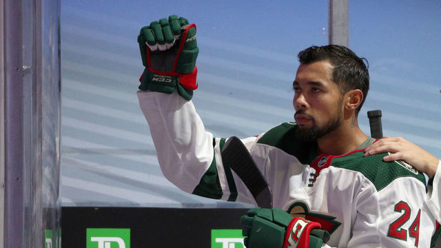 EDMONTON, ALBERTA - AUGUST 04: Jonas Brodin #25 of the Minnesota Wild puts his hand on Matt Dumba #24 (L) who raises his fist during the national anthem before Game Two of the Western Conference Qualification Round at Rogers Place against the Vancouver Canucks on August 04, 2020 in Edmonton, Alberta.