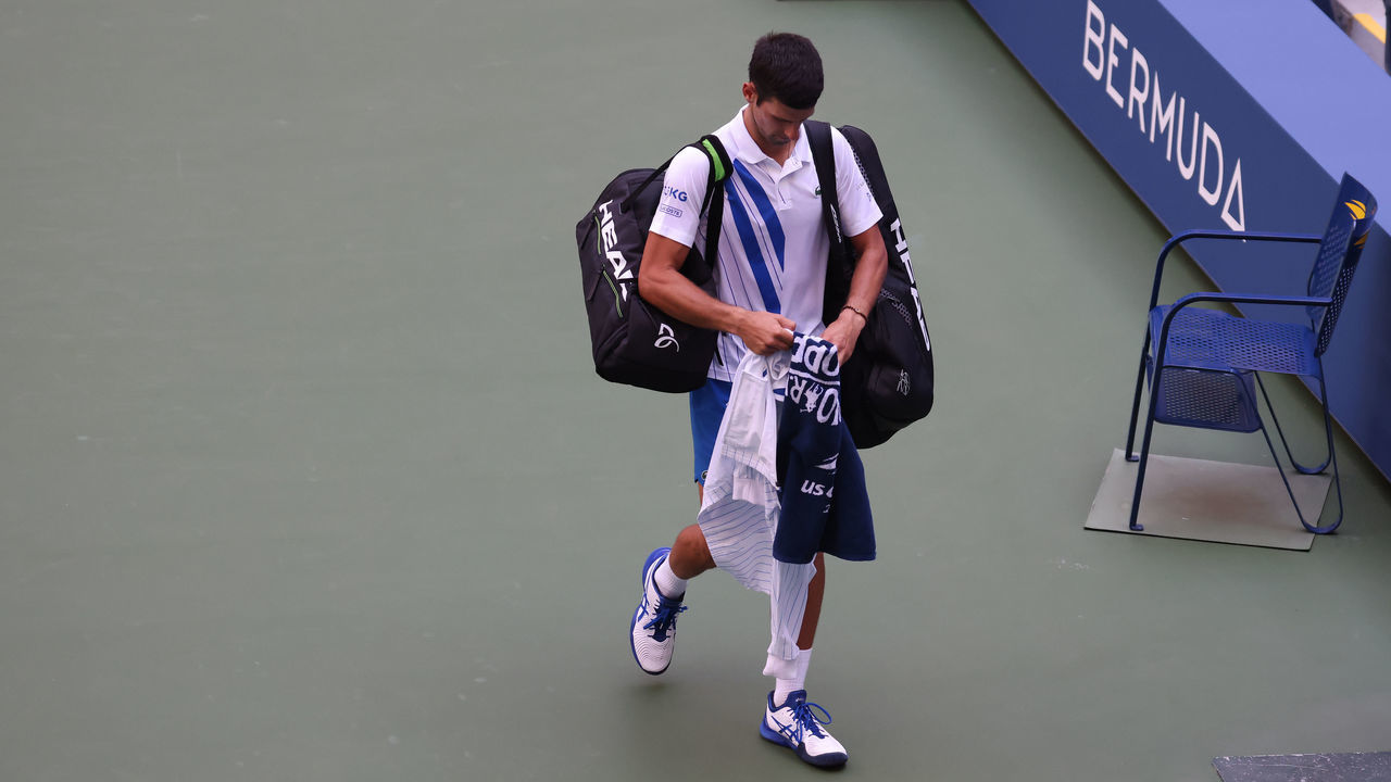 NEW YORK, NEW YORK - SEPTEMBER 06: Novak Djokovic of Serbia walks off the court after being defaulted due to inadvertently striking a lineswoman with a ball hit in frustration during his Men's Singles fourth round match against Pablo Carreno Busta of Spain on Day Seven of the 2020 US Open at the USTA Billie Jean King National Tennis Center on September 6, 2020 in the Queens borough of New York City.
