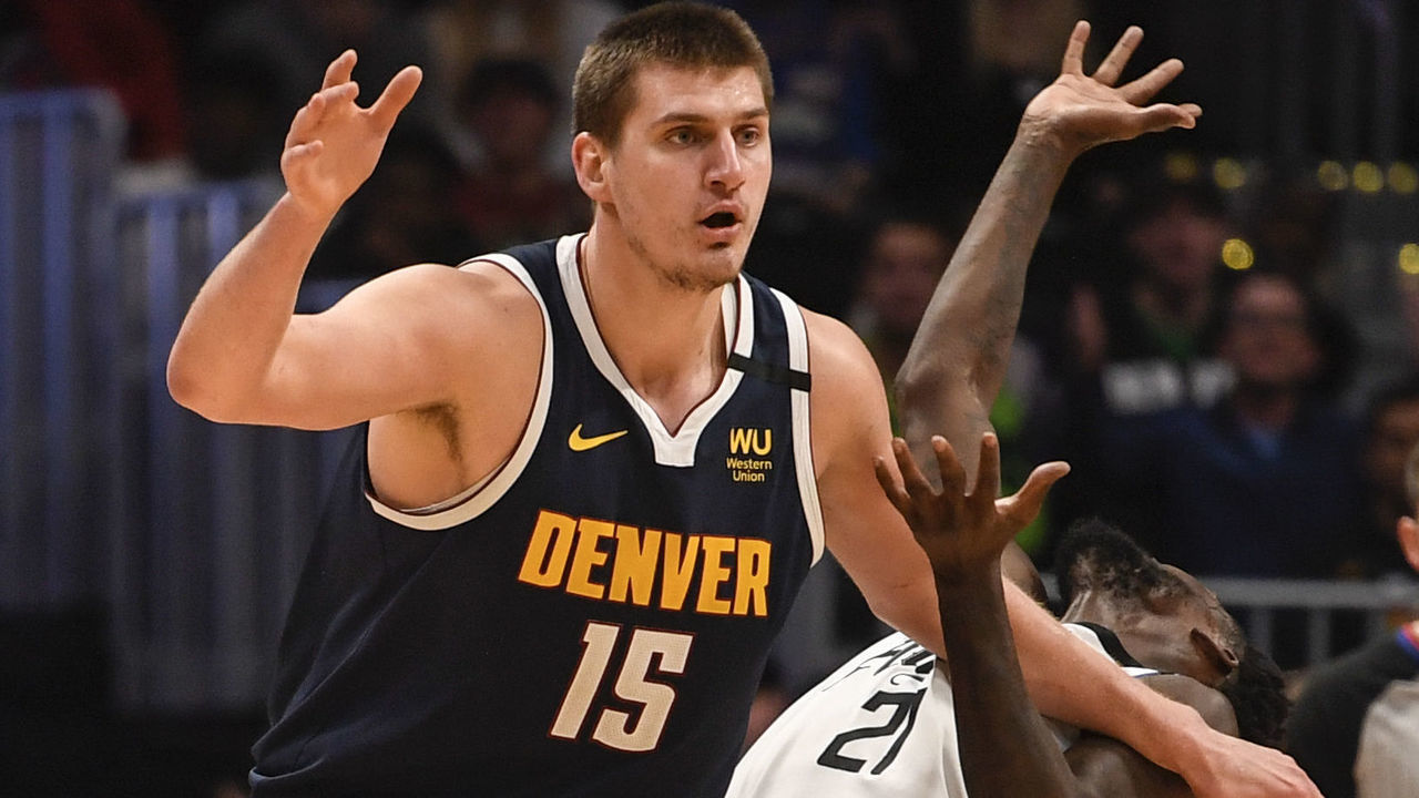 DENVER, CO - JANUARY 12: Nikola Jokic (15) of the Denver Nuggets hammers Patrick Beverley (21) of the LA Clippers before taking the ball in the post against the overmatched guard during the fourth quarter of Denver's 114-104 win on Sunday, January 12, 2020.