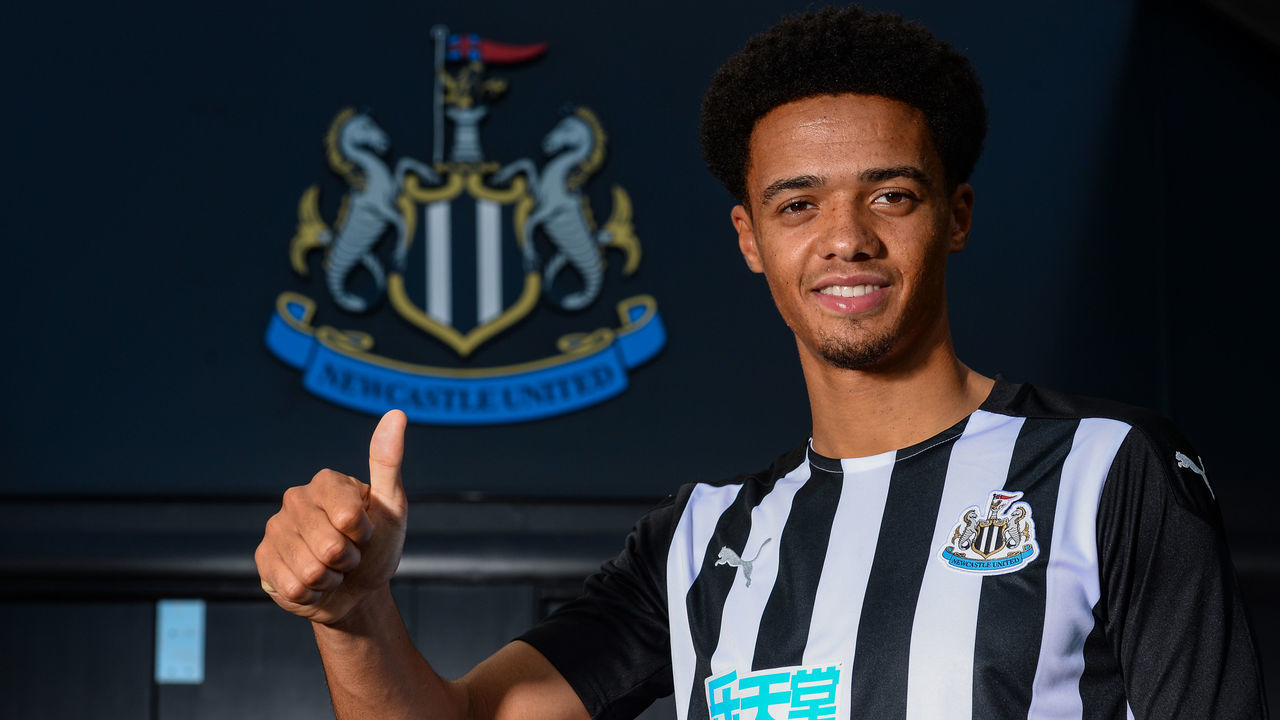 NEWCASTLE UPON TYNE, ENGLAND - SEPTEMBER 08: Jamal Lewis poses for photographs in front of the clubs crests wearing a home shirt at St.James' Park on September 08, 2020 in Newcastle upon Tyne, England.
