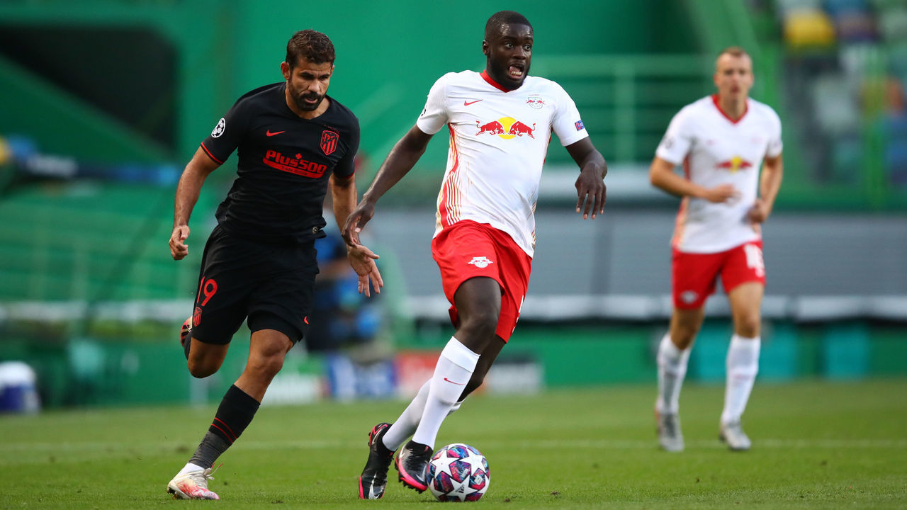 LISBON, PORTUGAL - AUGUST 13: Dayot Upamecano of RB Leipzig runs with the ball under pressure from Diego Costa of Atletico de Madrid during the UEFA Champions League Quarter Final match between RB Leipzig and Club Atletico de Madrid at Estadio Jose Alvalade on August 13, 2020 in Lisbon, Portugal.
