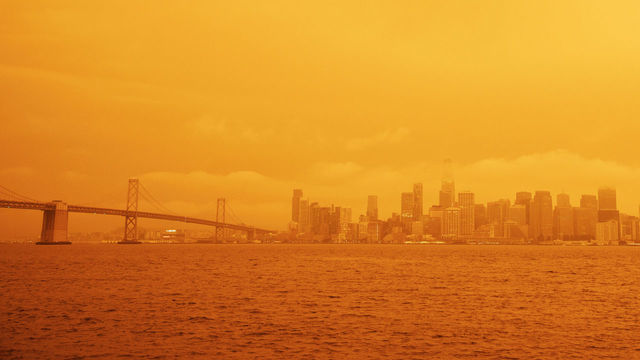 SAN FRANCISCO, USA - SEPTEMBER 09: A view of a layer of smoke generated by the over 2 dozen wildfires burning in California created and eerie orange glow over mush of the San Francisco Bay Area, California, United States on September 09, 2020. Fortunately a marine layer kept the smoke well above the ground improving air quality in the area.