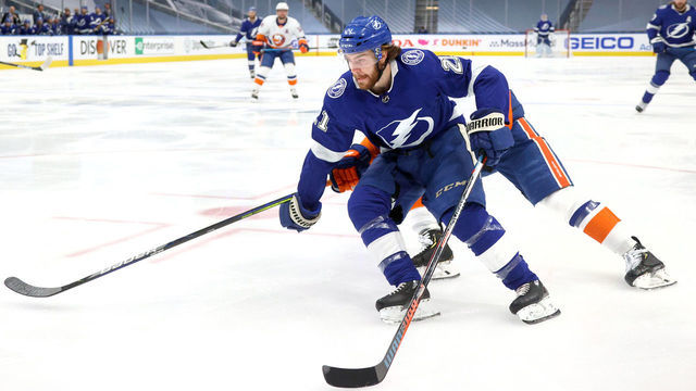 EDMONTON, ALBERTA - SEPTEMBER 07: Brayden Point #21 of the Tampa Bay Lightning skates the puck to the net around Ryan Pulock #6 of the New York Islanders in the first period of Game One of the Eastern Conference Final of the 2020 NHL Stanley Cup Playoffs between the New York Islanders and the Tampa Bay Lightning at Rogers Place on September 07, 2020 in Edmonton, Alberta.
