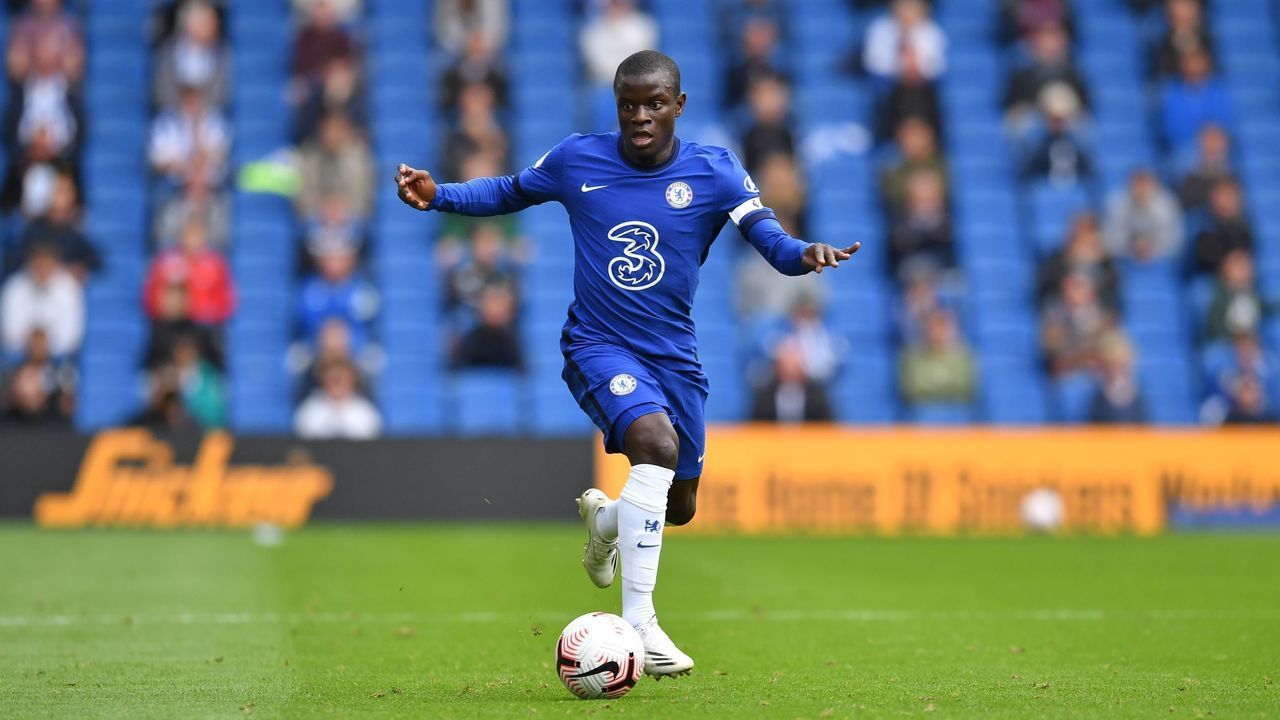 Chelsea's French midfielder N'Golo Kante runs with the ball as socially distanced fans watch from the stands during the pre-season friendly football match between Brighton and Hove Albion and Chelsea at the American Express Community Stadium in Brighton, southern England on August 29, 2020. - The game is a 'pilot' event where a small number of fans will be present on a socially-distanced basis. The aim is to get fans back into stadiums in the Premier League by October.