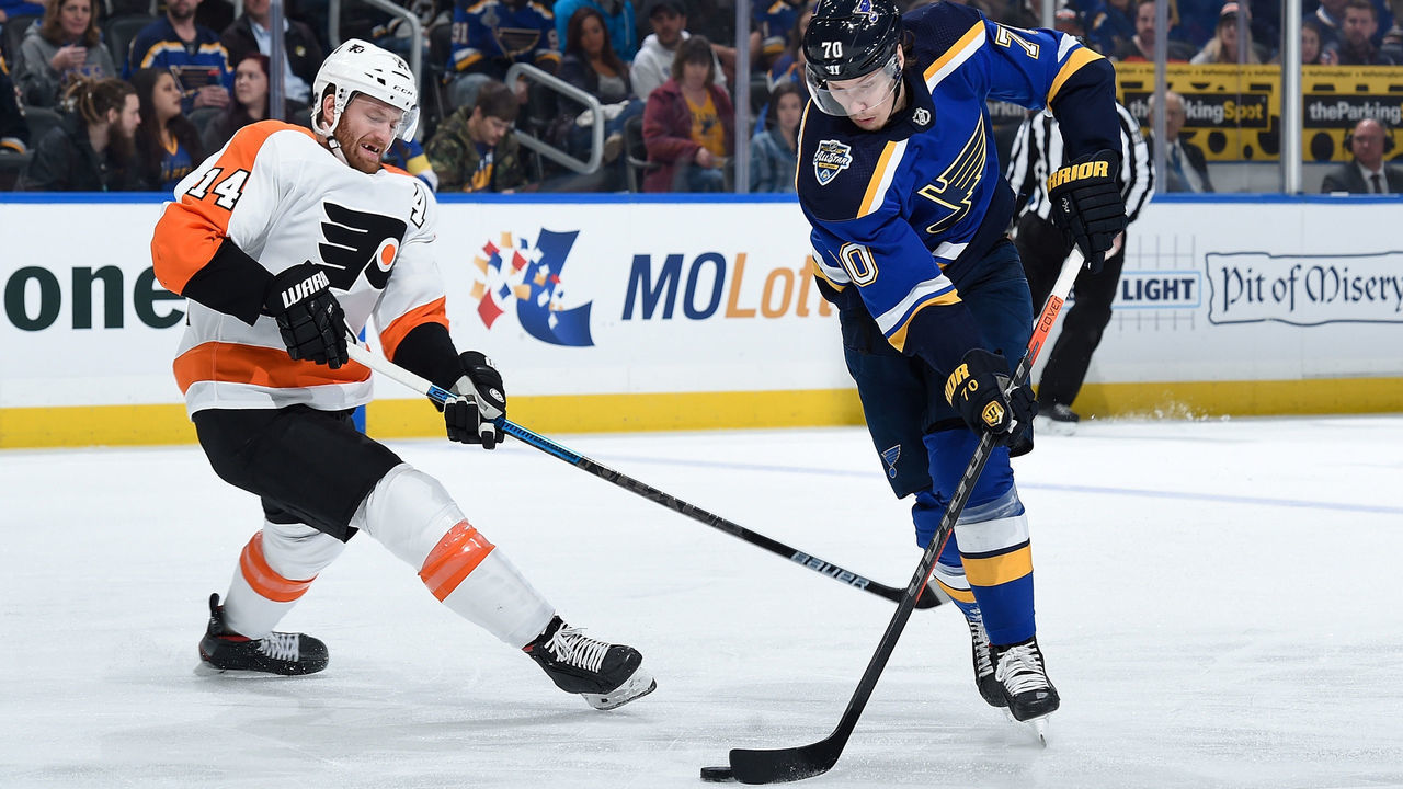 ST. LOUIS, MO - JANUARY 15: Sean Couturier #14 of the Philadelphia Flyers attempts to block a shot from Oskar Sundqvist #70 of the St. Louis Blues at Enterprise Center on January 15, 2020 in St. Louis, Missouri.