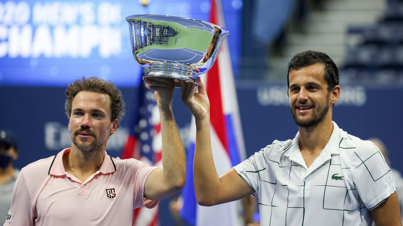 NEW YORK, NEW YORK - SEPTEMBER 10: Mate Pavic (R) of Croatia and Bruno Soares (L) of Brazil celebrate with the trophy after winning their Men's Doubles final match against Wesley Koolhof of the Netherlands and Nikola Mektic of Croatia on Day Eleven of the 2020 US Open at the USTA Billie Jean King National Tennis Center on September 10, 2020 in the Queens borough of New York City.
