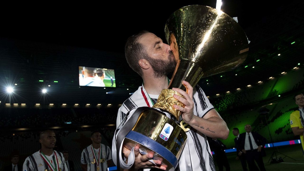 TURIN, ITALY - AUGUST 01: Gonzalo Higuain of Juventus celebrates winning the Italian championship "scudetto" 2019-2020 (ninth title in a row) with the trophy after the Serie A match between Juventus and AS Roma at Allianz Stadium on August 01, 2020 in Turin, Italy.