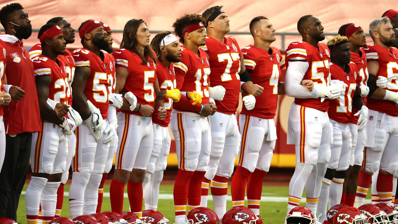 KANSAS CITY, MISSOURI - SEPTEMBER 10: Members of the Kansas City Chiefs stand united for with locked arms before the start of a gam against the Houston Texans at Arrowhead Stadium on September 10, 2020 in Kansas City, Missouri.