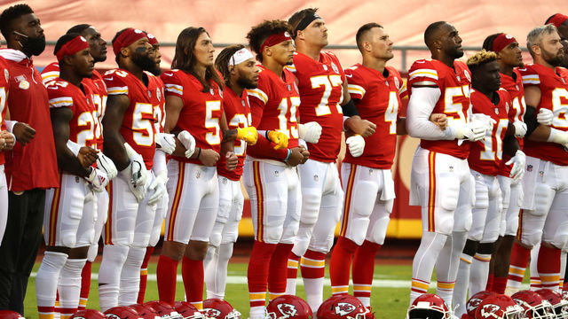 KANSAS CITY, MISSOURI - SEPTEMBER 10: Members of the Kansas City Chiefs stand united for with locked arms before the start of a gam against the Houston Texans at Arrowhead Stadium on September 10, 2020 in Kansas City, Missouri.