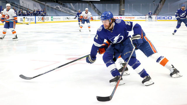 EDMONTON, ALBERTA - SEPTEMBER 07: Brayden Point #21 of the Tampa Bay Lightning skates the puck to the net around Ryan Pulock #6 of the New York Islanders in the first period of Game One of the Eastern Conference Final of the 2020 NHL Stanley Cup Playoffs between the New York Islanders and the Tampa Bay Lightning at Rogers Place on September 07, 2020 in Edmonton, Alberta.