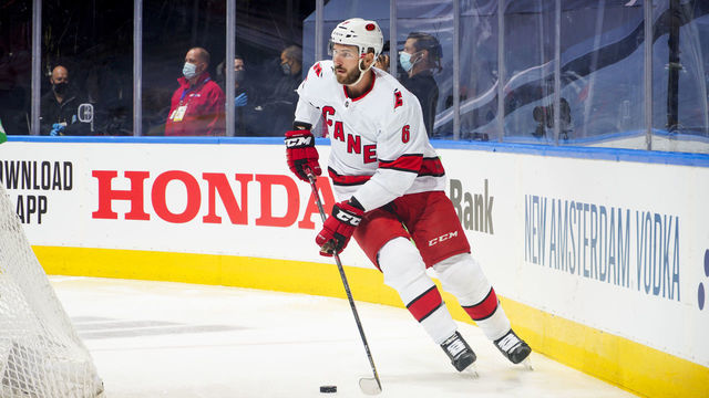 TORONTO, ONTARIO - AUGUST 12: Joel Edmundson #6 of the Carolina Hurricanes plays the puck against the Boston Bruins during the first during Game One of the Eastern Conference First Round of the 2020 NHL Stanley Cup Playoff at Scotiabank Arena on August 12, 2020 in Toronto, Ontario.