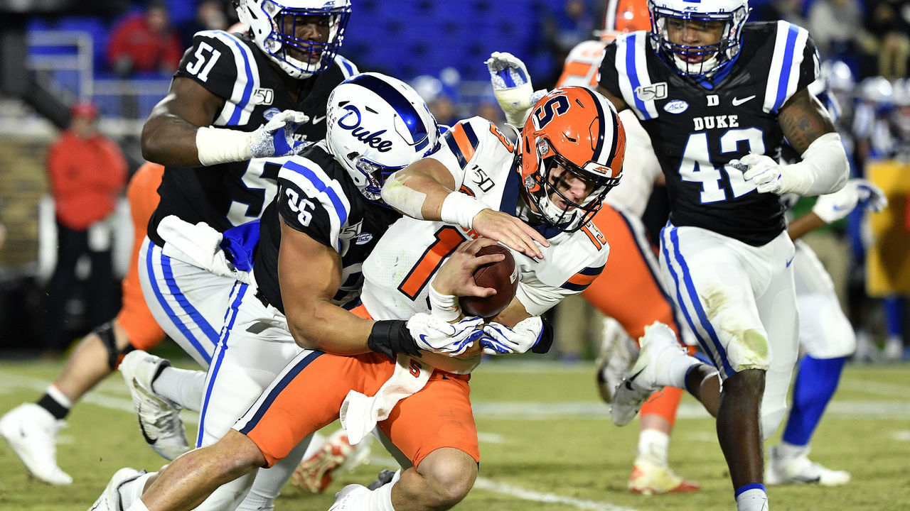 DURHAM, NORTH CAROLINA - NOVEMBER 16: Michael Carter II #26 of the Duke Blue Devils tackles Tommy DeVito #13 of the Syracuse Orange during the third quarter of their game at Wallace Wade Stadium on November 16, 2019 in Durham, North Carolina.