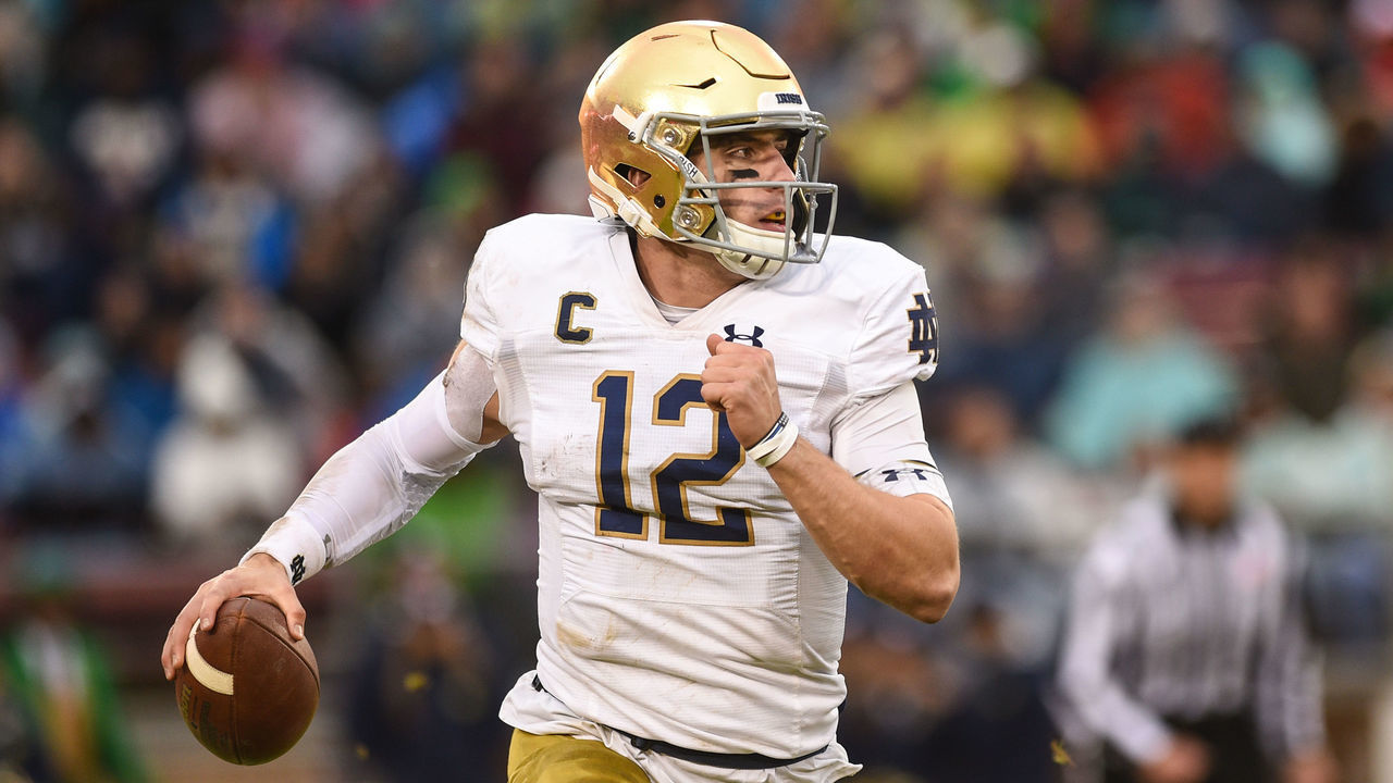 PALO ALTO, CA - NOVEMBER 30: Notre Dame quarterback Ian Book (12) rolls out of the pocket during the college football game between the Notre Dame Fighting Irish and Stanford Cardinal at Stanford Stadium on November 30, 2019 in Palo Alto, CA.