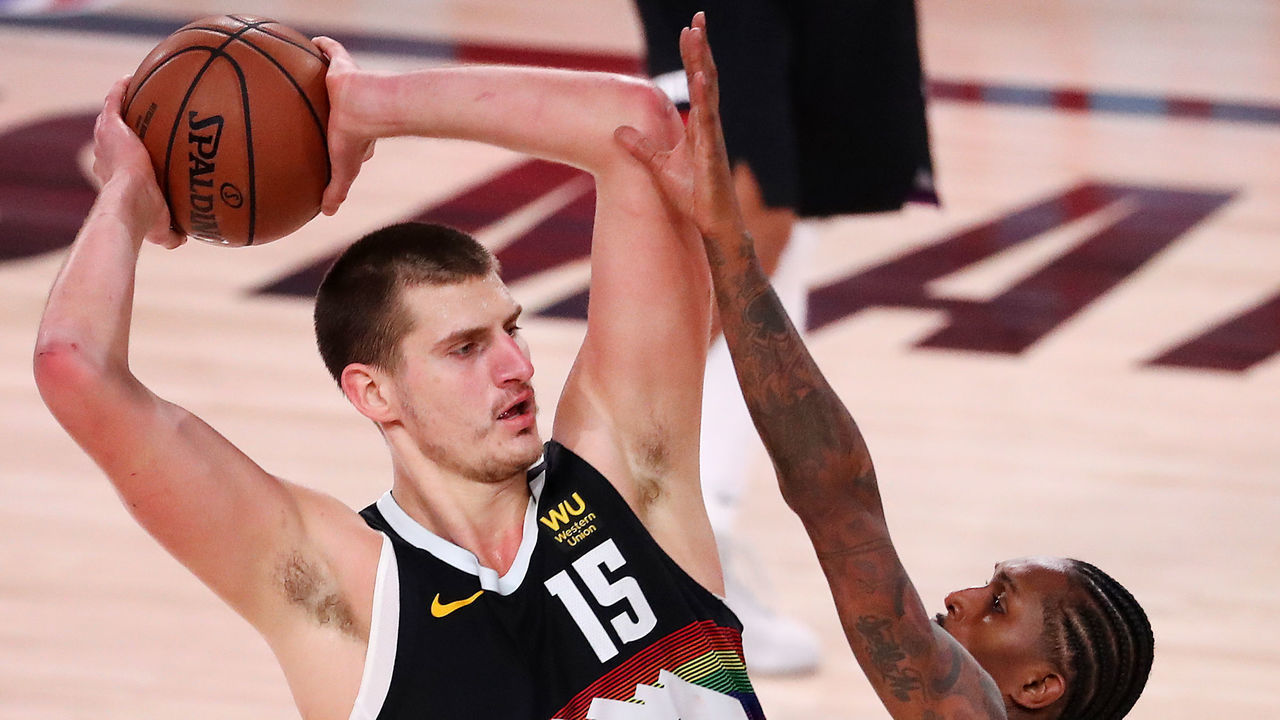 LAKE BUENA VISTA, FLORIDA - SEPTEMBER 13: Nikola Jokic #15 of the Denver Nuggets looks to pass the ball over Lou Williams #23 of the LA Clippers during the third quarter in Game Six of the Western Conference Second Round during the 2020 NBA Playoffs at AdventHealth Arena at the ESPN Wide World Of Sports Complex on September 12, 2020 in Lake Buena Vista, Florida.