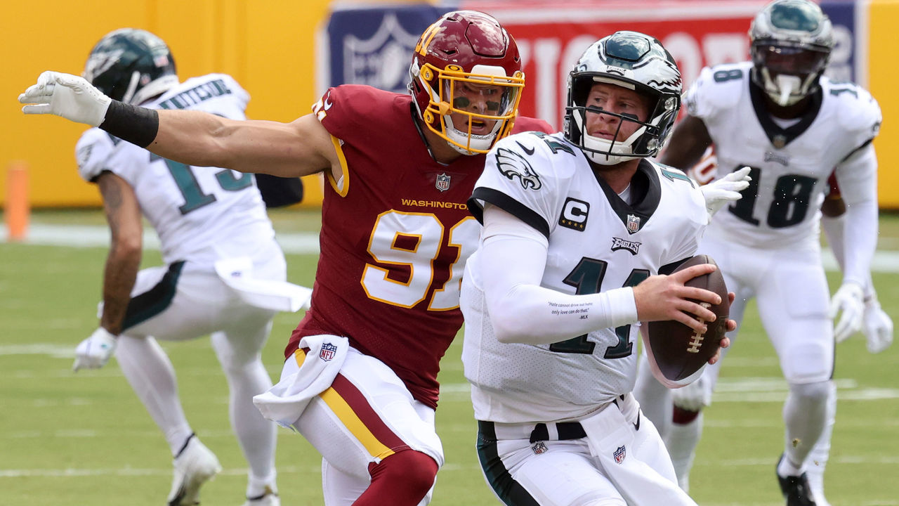 LANDOVER, MARYLAND - SEPTEMBER 13: Ryan Kerrigan #91 of the Washington Football Team sacks quarterback Carson Wentz #11 of the Philadelphia Eagles in the first half at FedExField on September 13, 2020 in Landover, Maryland.