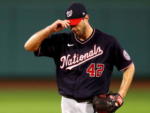 BOSTON, MASSACHUSETTS - AUGUST 28: Max Scherzer #42 of the Washington Nationals looks on during the third inning of the game against the Boston Red Sox at Fenway Park on August 28, 2020 in Boston, Massachusetts. All players are wearing #42 in honor of Jackie Robinson Day. The day honoring Jackie Robinson, traditionally held on April 15, was rescheduled due to the COVID-19 pandemic.